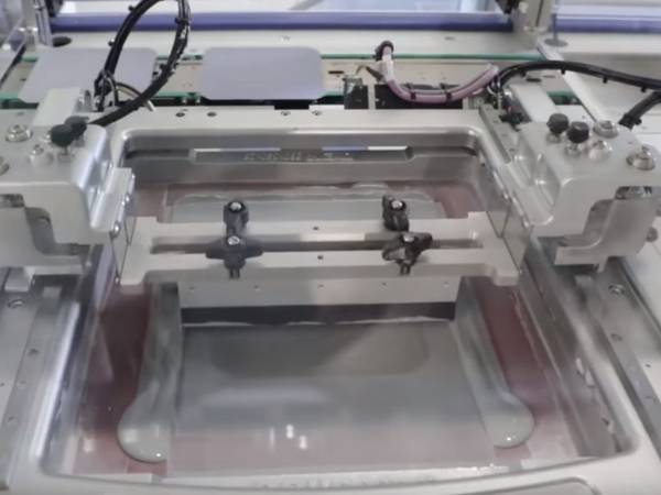 A machine is screen printing crystalline solar cell.