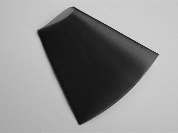 A piece of black color polyester filter tube on gray background.